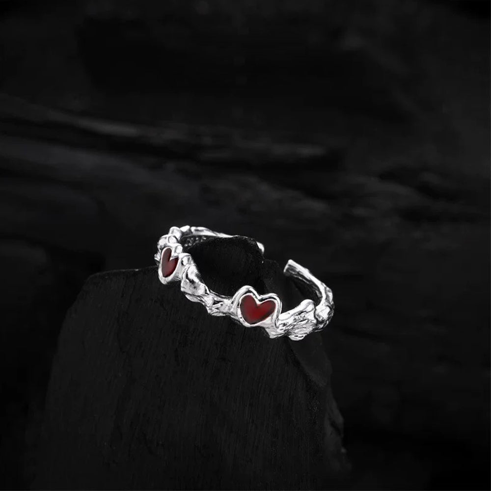 Side angle view of the Cupid's Heart Ring in silver, showcasing the elegant curves and intricate details of the band.