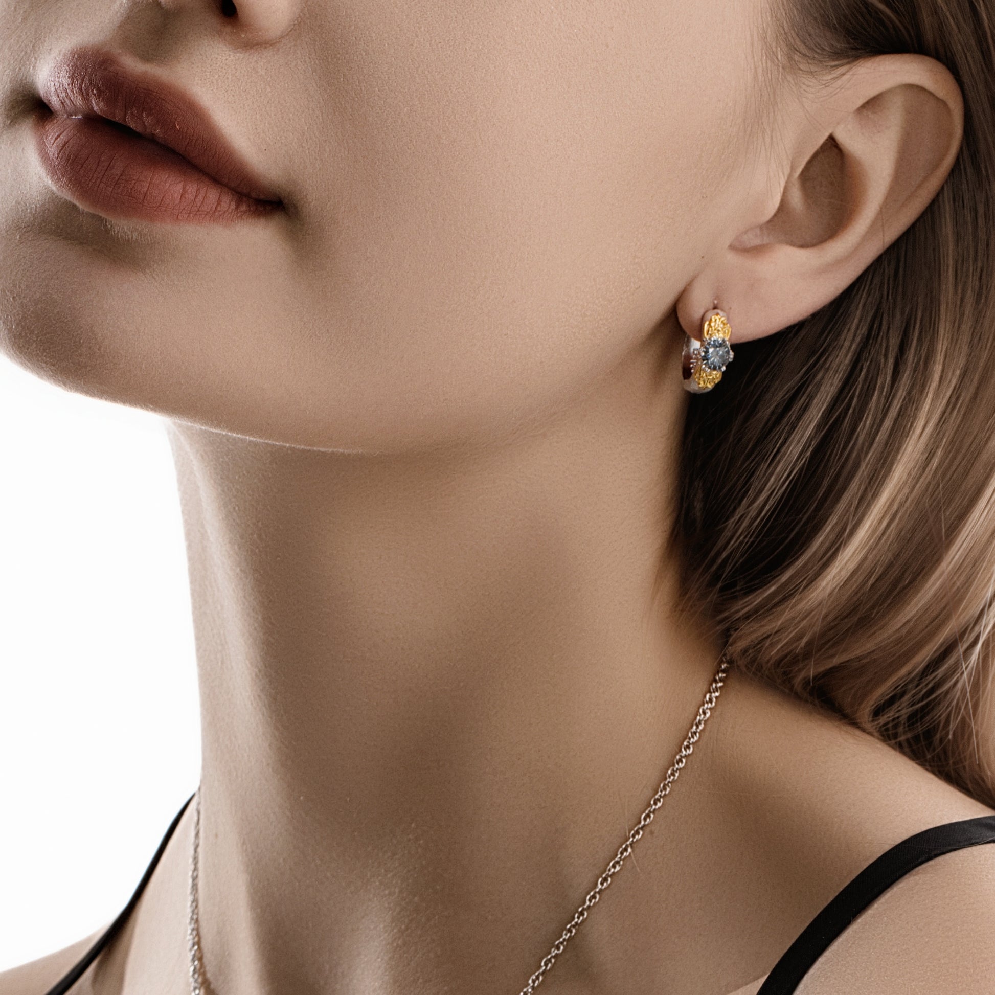 Model wearing the Eternal Gleam ear clips, gold version, capturing their refined sparkle and lacy texture.