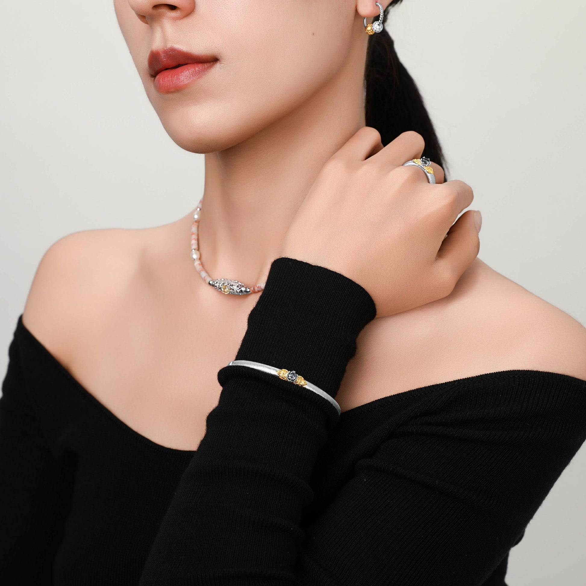 Close-up of the bangle on the model’s wrist, highlighting the delicate filigree and moissanite brilliance.