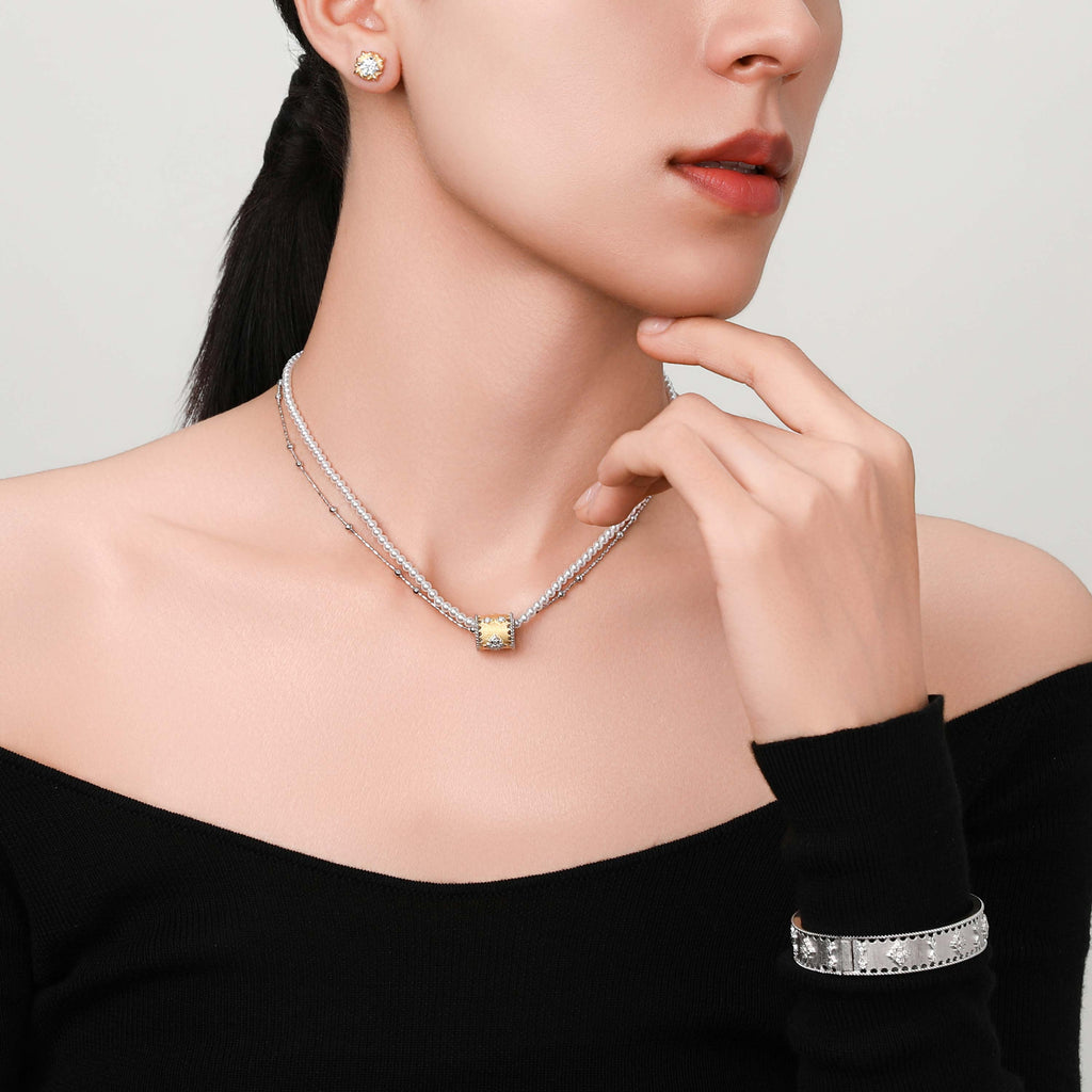 Lifestyle shot of model wearing the Baroque Bloom necklace paired with a minimalist outfit for contrast.