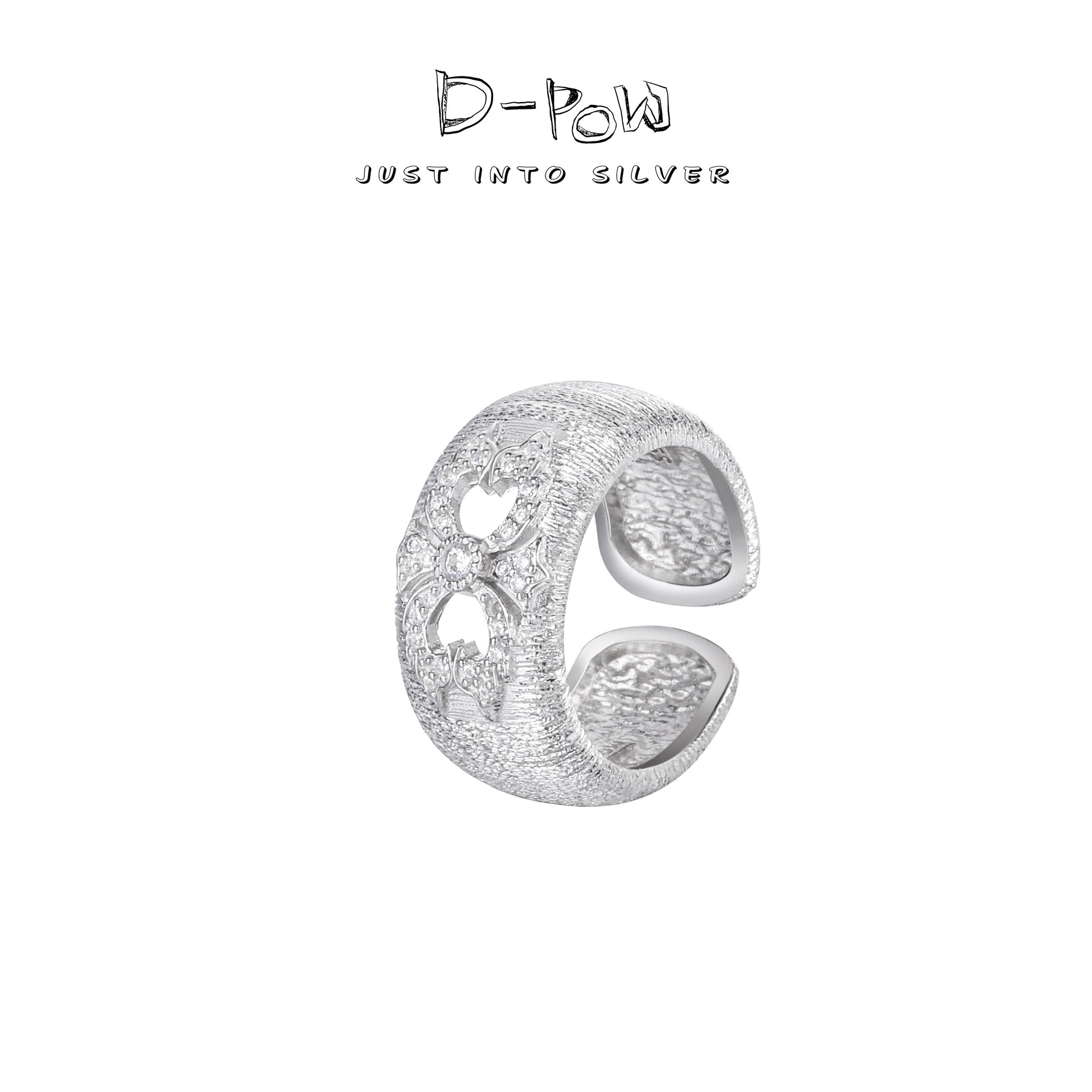 Side view showing the intricate filigree design of the D-POW "Ineffleur" ring with silk thread details