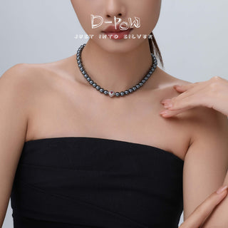 Model wearing the D-POW Cosmic Amour peach motif necklace, demonstrating how it elegantly rests around the neck, perfect for daily wear or special occasions.