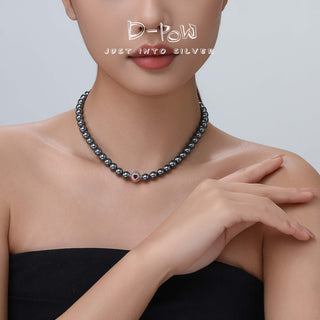 Close-up of the D-POW Cosmic Amour peach motif necklace worn by a model, focusing on the necklace’s elegant design and perfect fit.