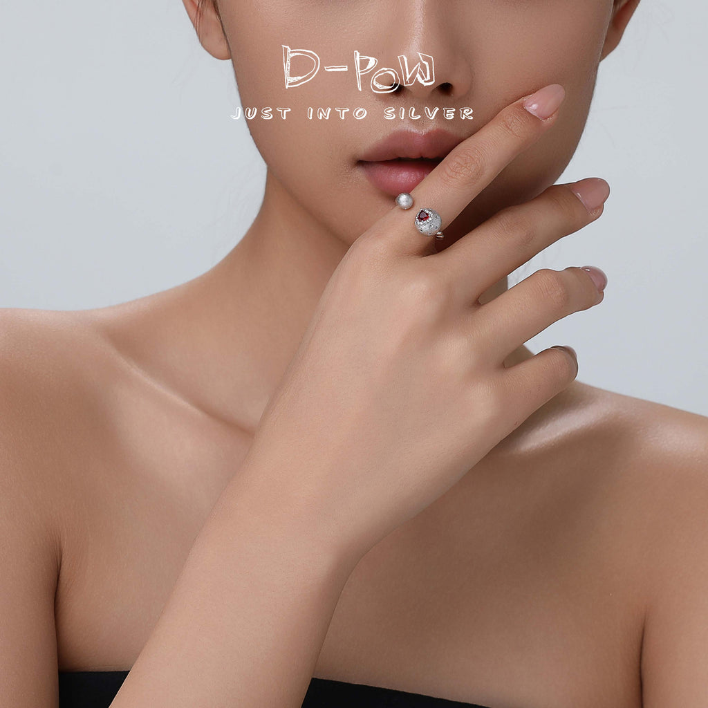 Close-up view of the D-POW Cosmic Amour 925 silver adjustable ring worn, emphasizing the intricate peach motif and fine details of the design.