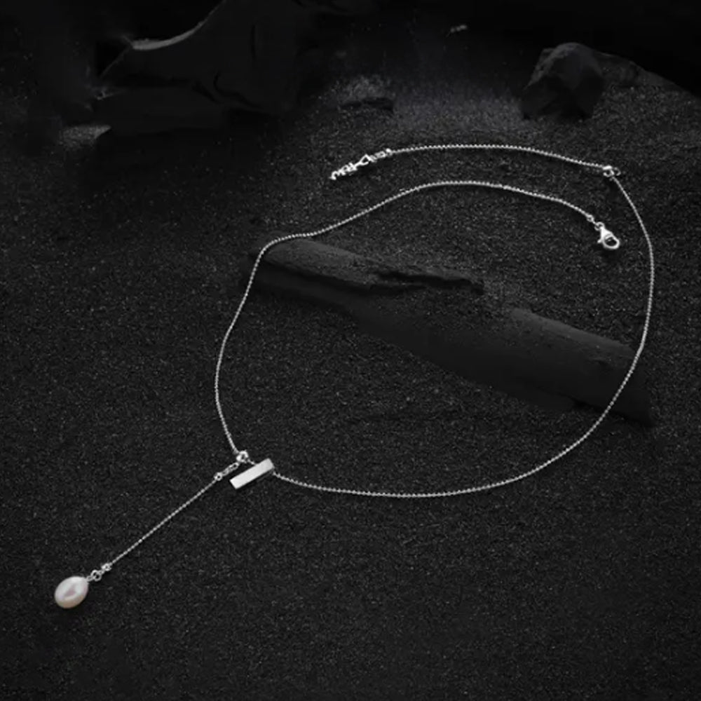 Letter "I" pendant from the cream-colored letter necklace, showing the refined design and detailed craftsmanship.