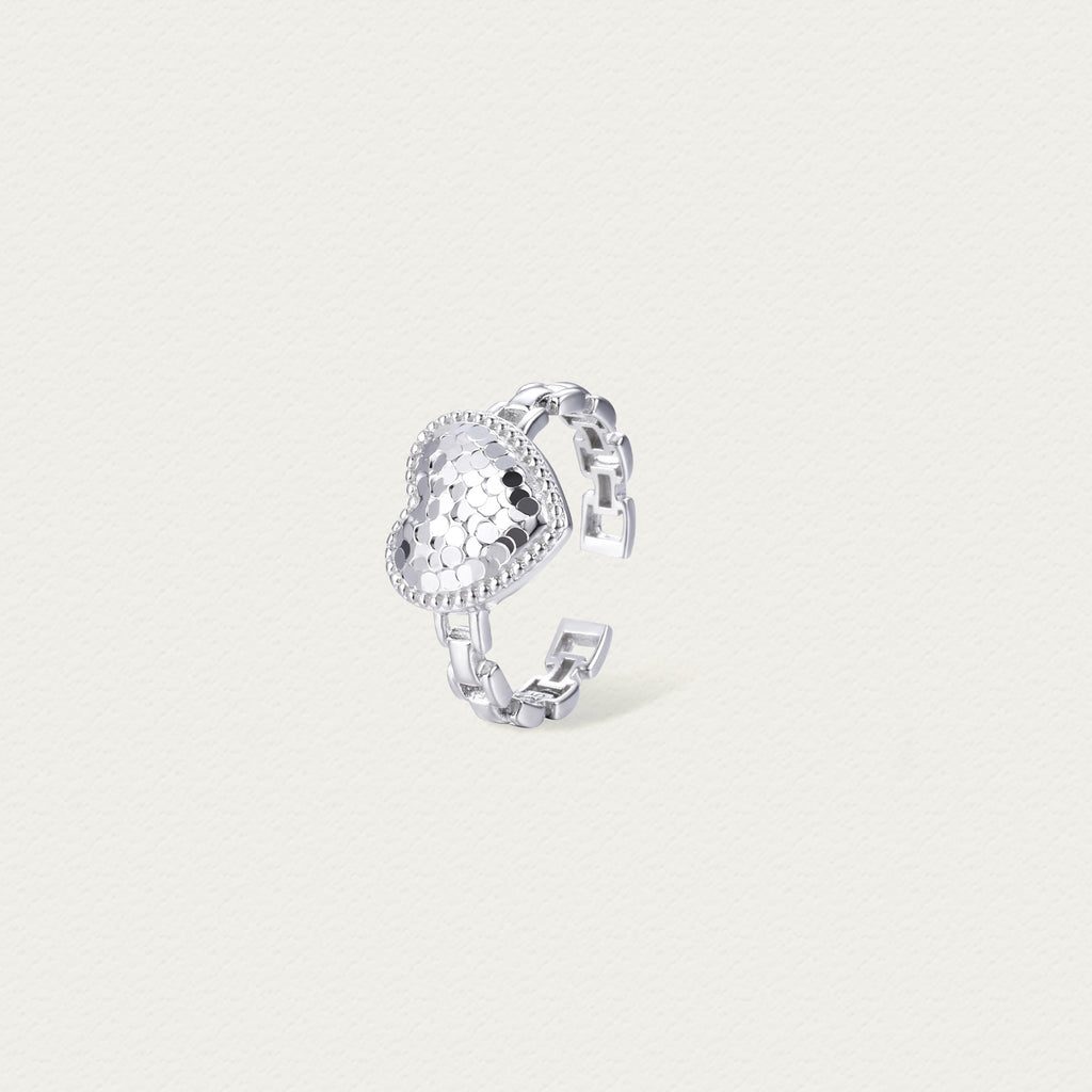Side view of the Crushed Ice Heart ring showcasing the layered heart design and refined silver band.