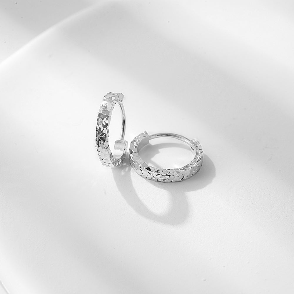 Front view of the D.POW crushed ice hoop earrings in sterling silver, highlighting the shimmering textured surface.