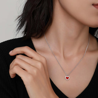 Model wearing the Cupid's Heart Necklace, showing the pendant resting elegantly on the collarbone.