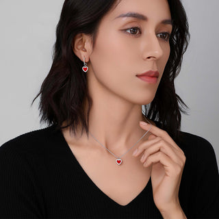 Side view of the Cupid's Heart Necklace on model, highlighting how the red heart pendant catches the light.