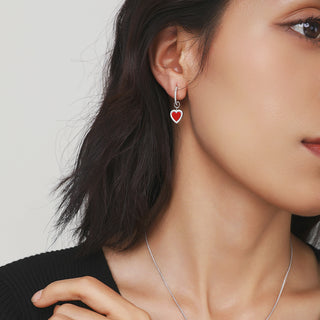 Model wearing one Cupid's Heart earring, displaying the elegant drop length and vivid red gemstone.
