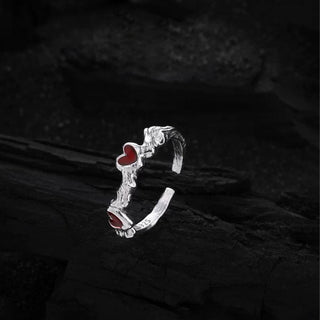 Close-up of the Cupid's Heart Ring in silver, emphasizing the fine craftsmanship and shimmering surface of the heart motif.