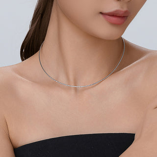 Model wearing the Essential Dainty Meteor necklace, displaying how the silver pendant sits subtly and elegantly at the collarbone.