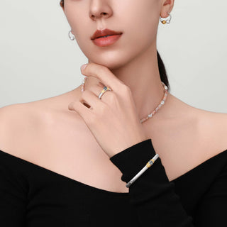 Close-up of the ring on the model’s hand, emphasizing the refined filigree craftsmanship and center stone.