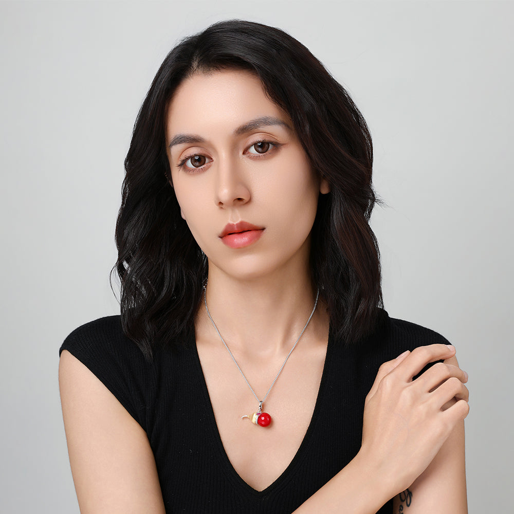 Model wearing the Festive Lucky Gourd necklace, highlighting its vibrant red hue and symbolic design near the collarbone.