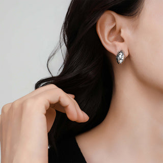 Model wearing the Frozen Echo shell ear cuff, illustrating how it gracefully wraps the ear with a minimalist ocean-inspired elegance.