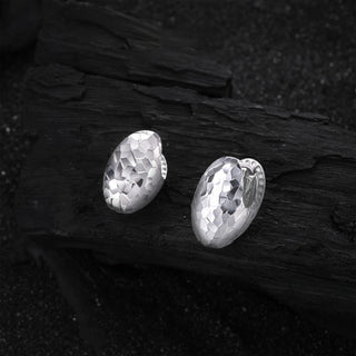 Side angle of the Frozen Echo silver shell ear cuff, showcasing its layered design and subtle curvature.