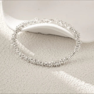 Close-up shot of the Heavy Craft Silver Fragment Bracelet, highlighting the textured silver fragments and high-quality craftsmanship.