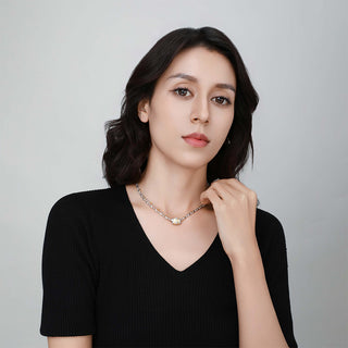 Close-up of the Ice Crystal necklace in silver as worn by the model, capturing the subtle sparkle and modern silhouette.