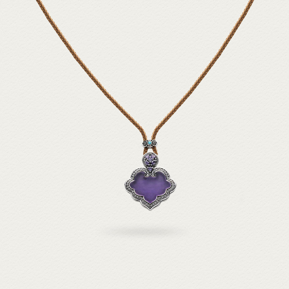 Close-up of the purple Lustre Ruyi necklace, showcasing the intricate design and texture of the brown rope and clasp.