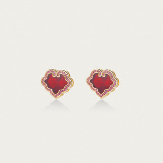 Front view of Lustre Ruyi stud earrings featuring red sparkling stones and silver ruyi motif.