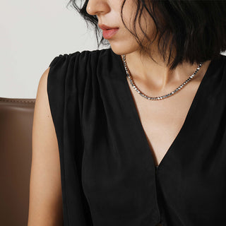 Model wearing the Shatterlight Multi-Faceted Heavy Craft Necklace, showcasing how the pendant rests elegantly on the chest, drawing attention to its bold design.