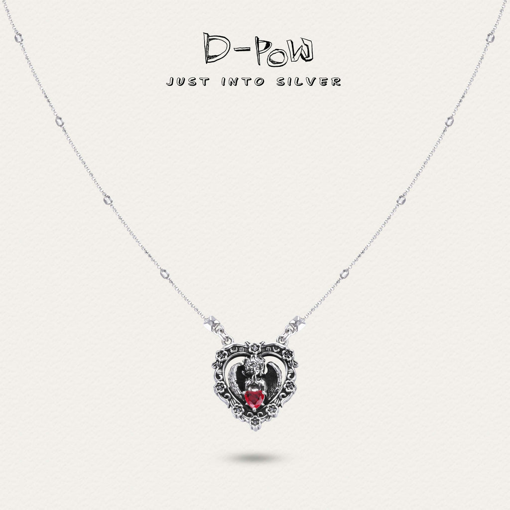 Close-up of D-POW Seraph's Silence sterling silver necklace featuring a heart-shaped red gem, highlighting its exquisite craftsmanship.