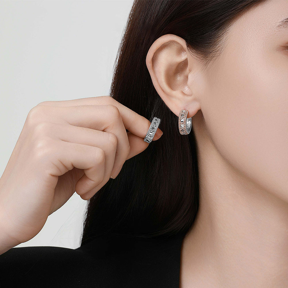 Model showcasing the Tindall Light ear clip, capturing its shimmering detail and unique ear-hugging silhouette.