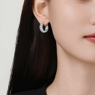 Lifestyle shot of the Tindall Light ear clip worn on one ear, blending statement design with understated elegance.