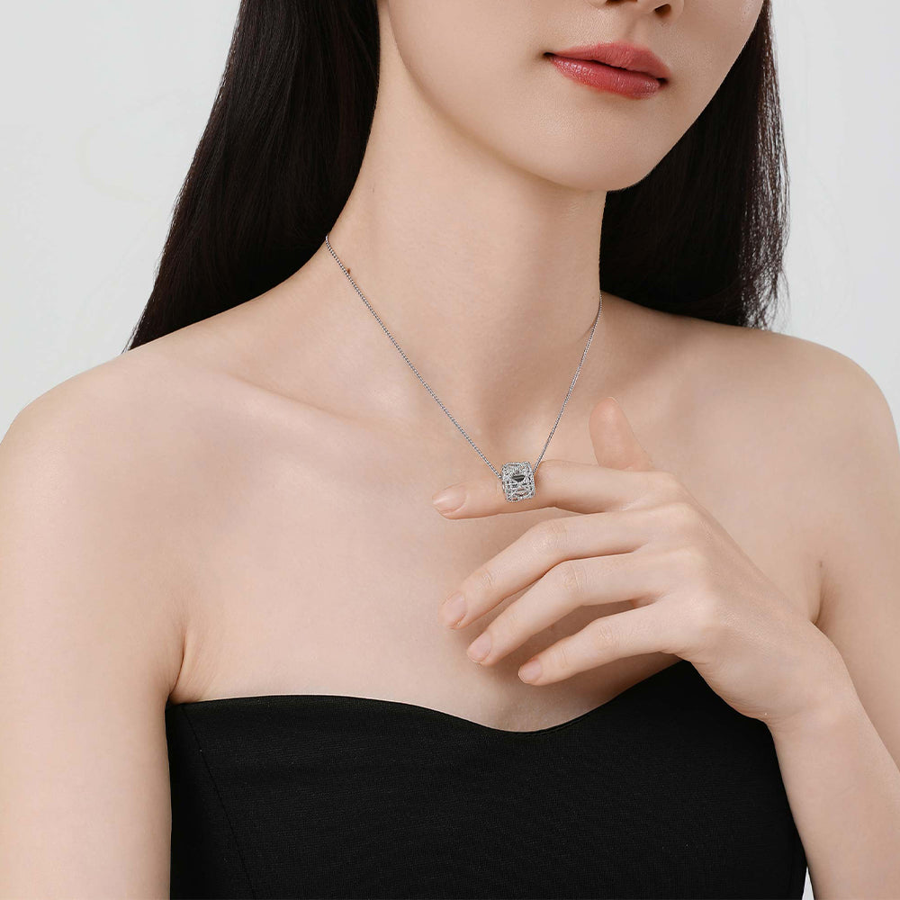 Model wearing the Tindall Light pendant, emphasizing the pendant's ethereal ice lace detail against the skin.